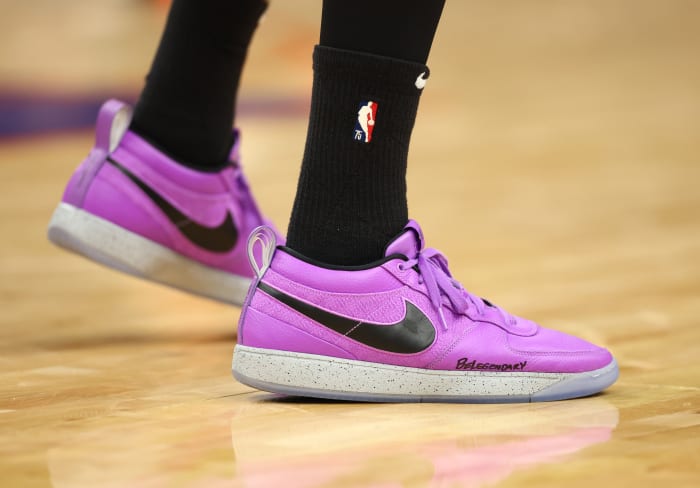 Phoenix Suns guard Devin Booker's purple and black Nike sneakers.